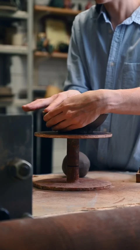 Potter's wheel for hand work, Master makes a plate by hand. Vertical format Stock Footage 293956936