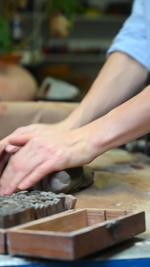 Potter's wheel for hand work, Master makes a plate by hand. Vertical format Stock Footage 293956947