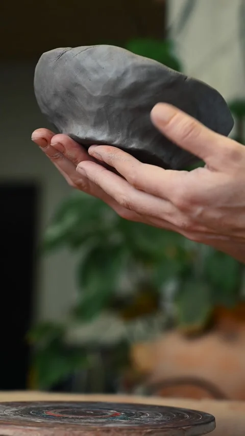 Potter's wheel for hand work, Master makes a plate by hand. Vertical format Stock Footage 294107337