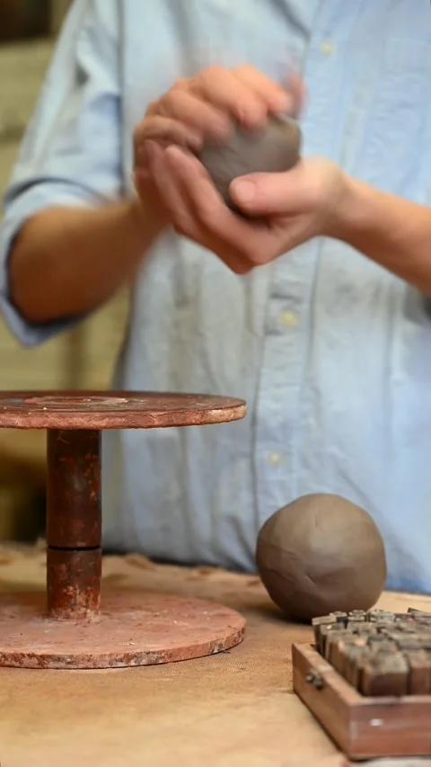 Potter's wheel for hand work, Master makes a plate by hand. Vertical format Stock Footage 294107687