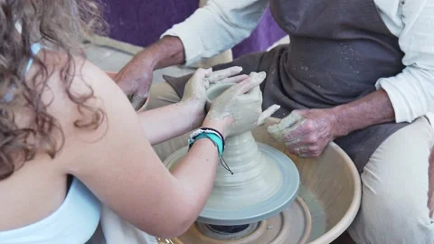 Potters working to shape the clay on the spinning wheel in the workshop. Stock Footage 220127475