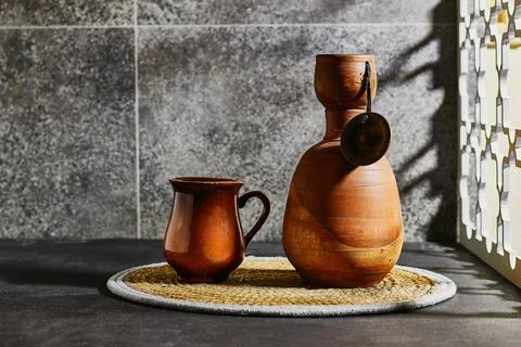 Pottery ceramic sake bottle and matching cup set, perfect for traditional Japane Stock Photos