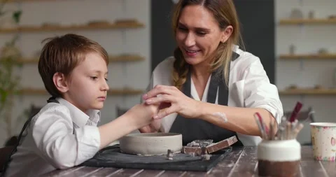 Pottery class workshop. Mom and child spend time together doing creative work Stock Footage 157737043
