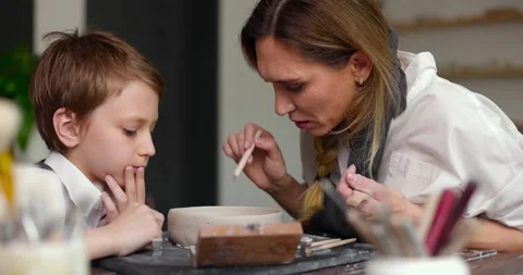 Pottery class workshop. Mom and child spend time together doing creative work Stock Footage 157836452