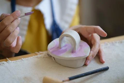 Pottery creation: creative process in potter studio with female ceramist Stock Photos