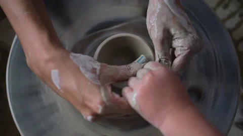 Pottery handcraft art lessons for small children, close up of adult hands Stock Footage 169351706
