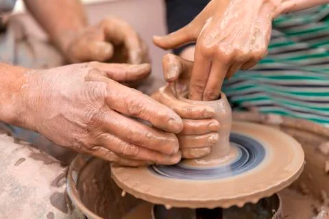 Pottery making. Hands working on pottery wheel Stock Photos
