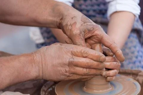 Pottery making. Hands working on pottery wheel Stock Photos