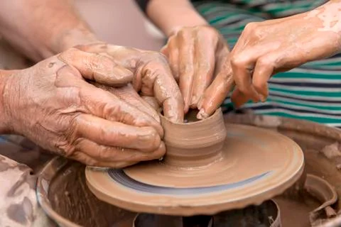 Pottery making. Hands working on pottery wheel Stock Photos