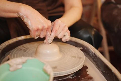 Pottery making process in a craft studio with hands shaping clay Stock Photos