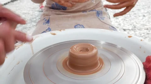 Pottery making on spinning table for pot mold. Close up hands of a sculptor girl Stock Footage 293133862