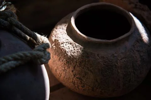 In the pottery shop, the sun's rays fall on the pottery. A clay pot and a jug Stock Photos