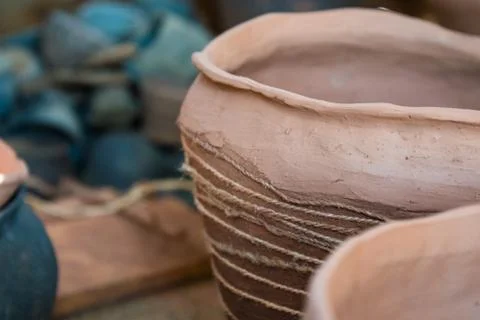 In the pottery shop, the sun's rays fall on the pottery. A clay pot and a jug Stock Photos