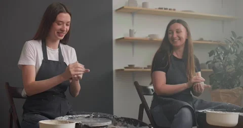 Pottery studio concept. Two young woman preparing clay workpieces. Smiles and Stock Footage 155652138