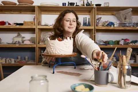 Pottery Studio Owner Working on Ceramic Sculpture in Small Business Art Wor.. Stock Photos