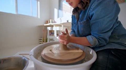 Pottery studio woman’s hands shaping clay on pottery wheel Stock Footage 221949705