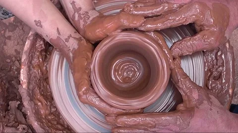 Pottery wheel top view, hands of two people sculpt a product from clay Stock Footage 146718208