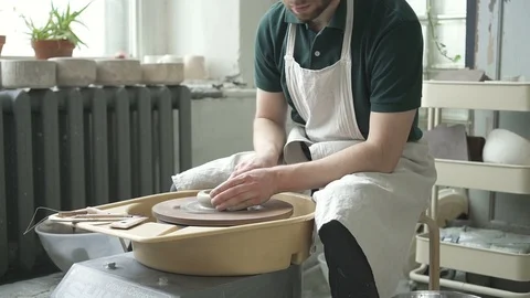 In pottery workshop craftsman makes a pitcher on a potter's wheel. Stock Footage 90130530