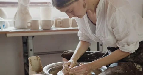 Pottery workshop. Cropped view of the female hands pulling the clay in oblong Stock Footage 218430623
