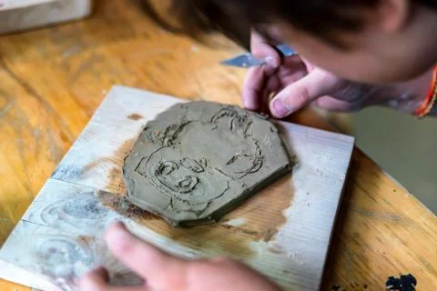 Pottery workshop. hands make print on clay Stock Photos