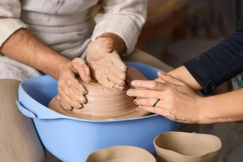 Pottery workshop hands shaping clay on wheel, creative craftsmanship and arti Stock Photos
