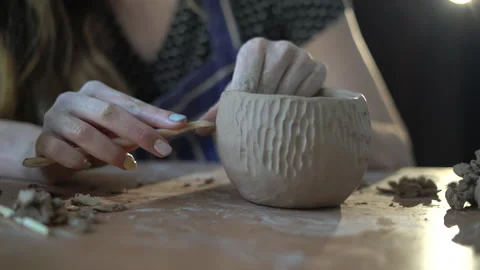 Pottery workshop, raw clay, sculpting tools, clay pot pattern shaping. close-up Stock Footage 155181878