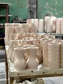 In a pottery workshop, various ceramic vases and pots made from clay are neat Stock Photos
