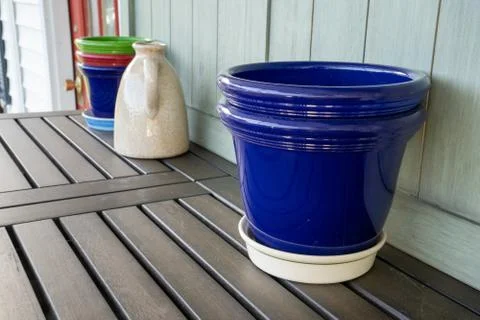 Potting bench with empty pots and water jug Stock Photos