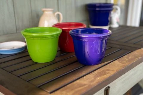 Potting bench with empty pots and water jug Stock Photos