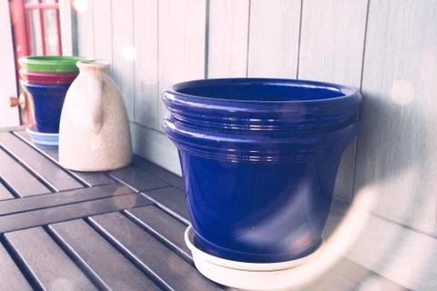 Potting bench with empty pots and water jug Stock Photos
