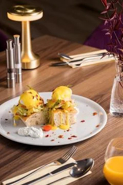 Pouched eggs on a panini bread. Breakfast in a fancy restaurant Stock Photos