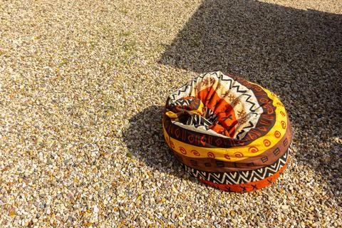 A pouf for sitting in the backyard with drawings based on African motifs Stock Photos