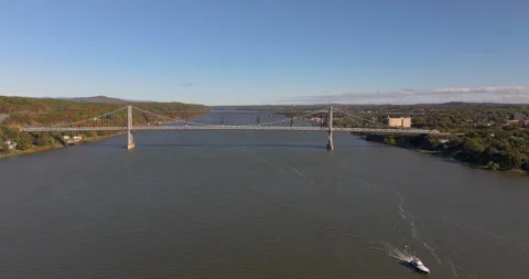 Poughkeepsie Bridges Autumn Pull Back with Boat Stock Footage 329818378