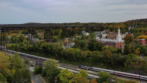Poughkeepsie NY Fall Foliage Hudson River Walkway flyover shore trains Stock Footage 144417376