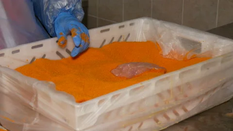 Poultry farm worker make chicken schnitzel in breadcrumbs. Stock Footage 185422307