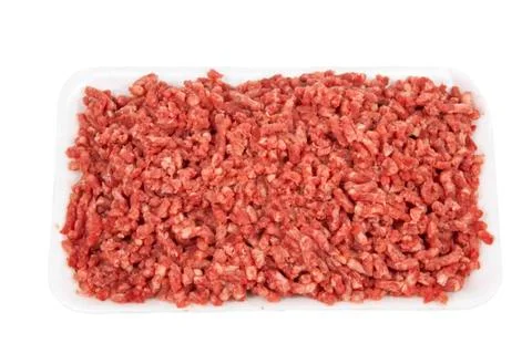 Pound of raw ground beef on white plate Stock Photos