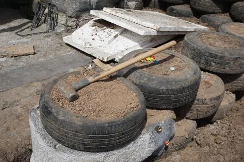Pounded tires wall structure with earth Stock Photos