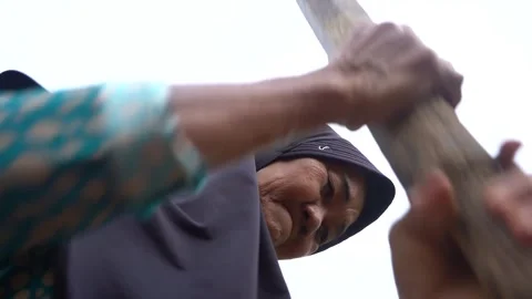 Pounding rice manually Stock Footage 272968048