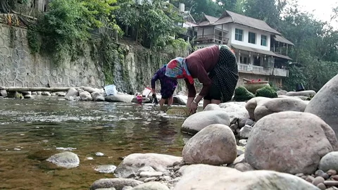 Pounding river weed, moss, for cooking Stock Footage 158901267