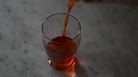 Pour and drink red alcohol glass in a marble table. Stock Footage 236452980