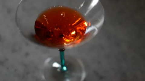 Pour and drink red alcohol glass in a marble table. Stock Footage 236453130