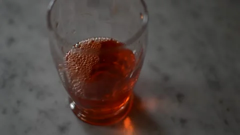 Pour and drink red alcohol glass in a marble table. Stock Footage 236453135
