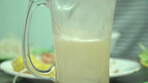 Pour beer into a cup with ice Stock Footage 139751452