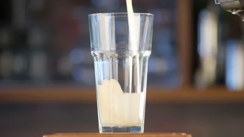 Pour beer into a transparent glass on the bar. Light, golden beer pours into a Stock Footage 156508853