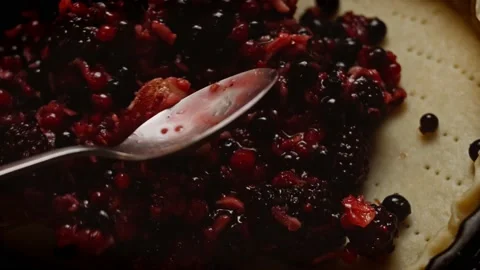 Pour the berry mixture into the dough for for Bluberry Pie. 4k video Stock Footage 159998395