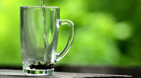 Pour boiling water over the tea leaves Stock Footage 24895070