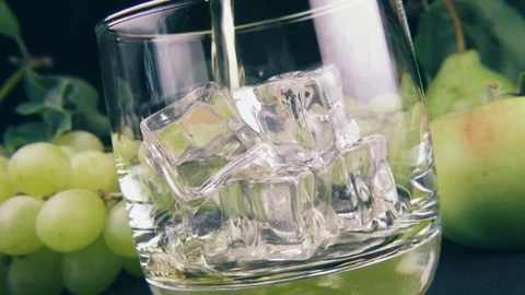 Pour bourbon into a glass of ice Stock Footage 91977650