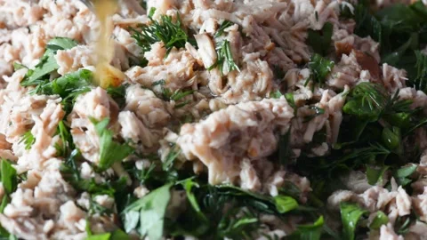 Pour the broth sauce and stir with a knife parsley, green onions and meat for th Stock Footage 130790809