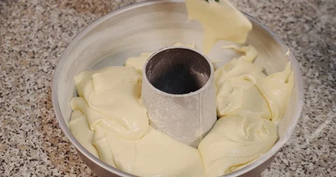 Pour the cake mixture into the circular baking tray Stock Footage 129155327