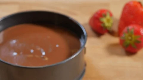 Pour chocolate mixture into the cake tin. making pastry chocolate cake Stock Footage 111637372